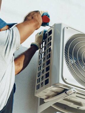 repairman-in-uniform-installing-the-outside-unit-of-air-conditioner-1